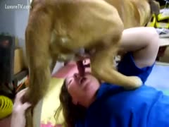 A woman gives her dog an oral job.